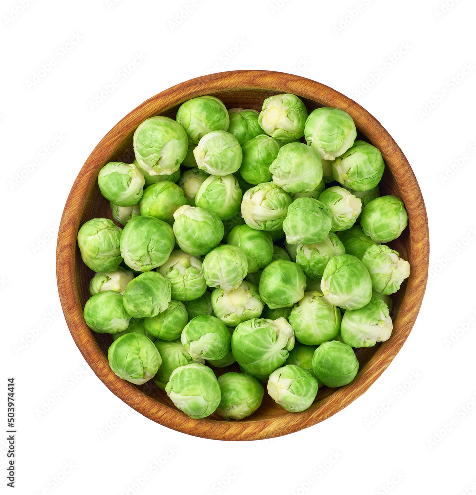 fresh brussel sprouts in a wooden bowl isolated on white background, top view. fresh brussel sprouts in a wooden bowl isolated on white background, top view.