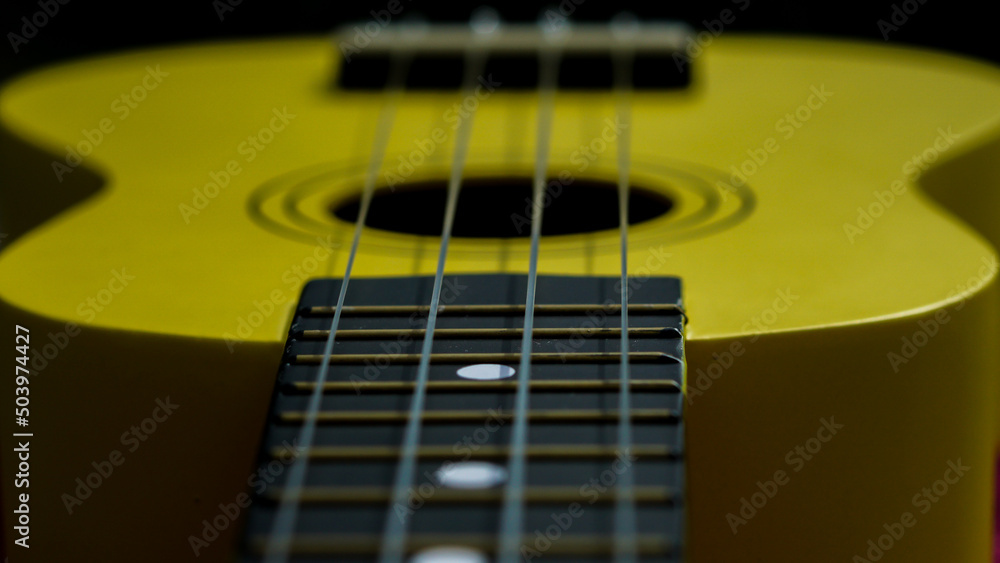Fototapeta premium close up ukulele, yellow guitar with strings