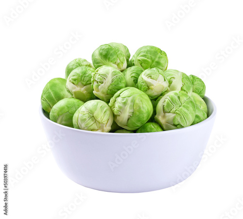 organic brussel sprouts in a white bowl isolated on white background.