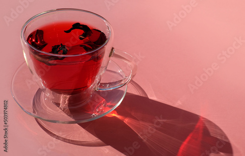 Tea cup on pink background, close-up, light and shadow