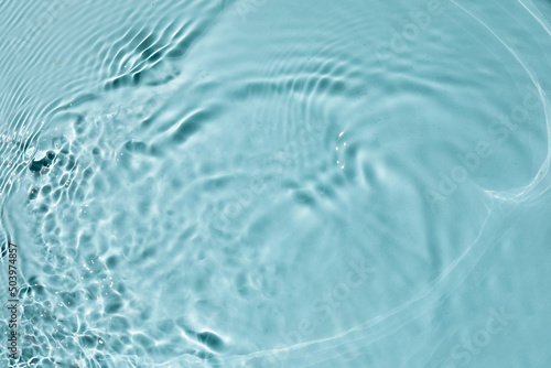 Trendy summer nature banner. Defocused aqua-mint liquid colored clear water surface texture with splashes bubbles. Water waves in sunlight background.  © Miha Creative