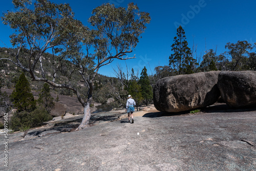 Woman hiking to The Junction in Girraween National Park, Queensland, Australia photo
