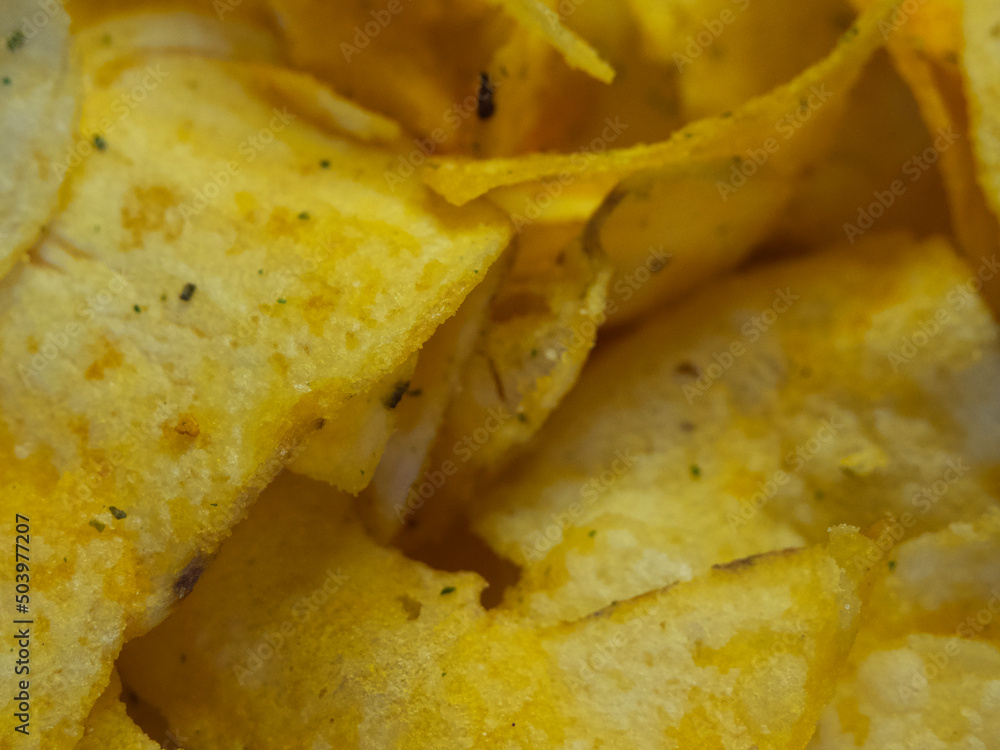 Spiced potato chips, a close-up shot. Fried potatoes. Spiced potato chips, a close-up shot. Fried potatoes.