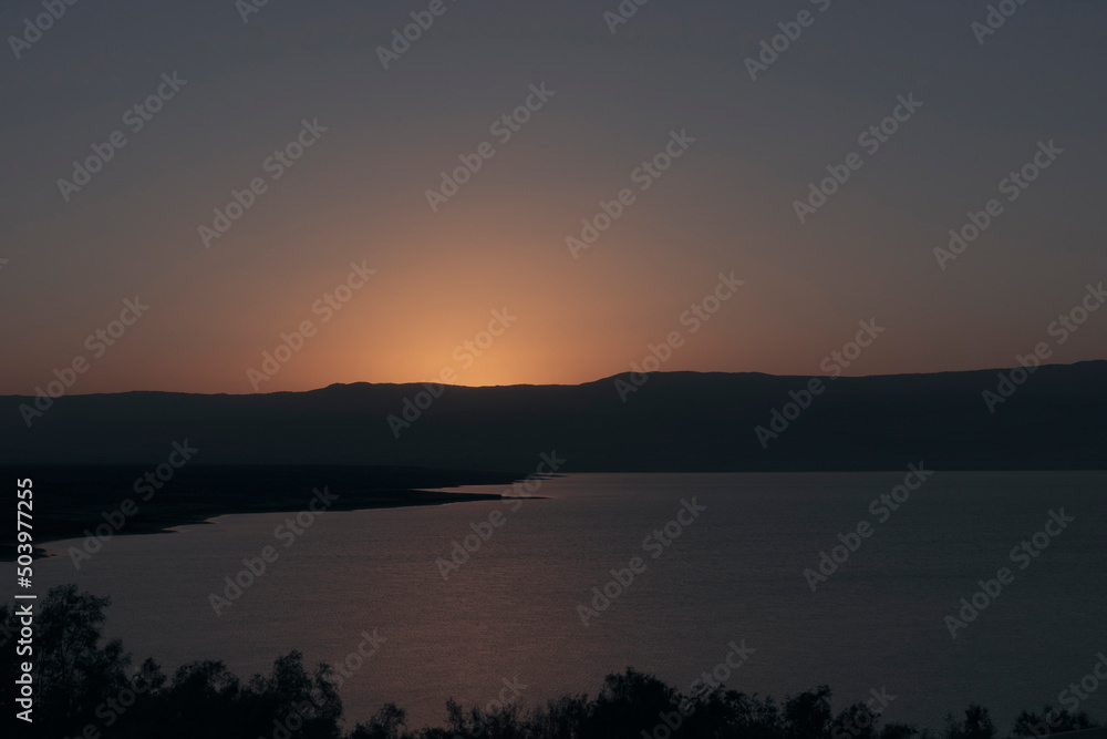 Orange sunrise reflecting off of the Dead Sea. High quality photo