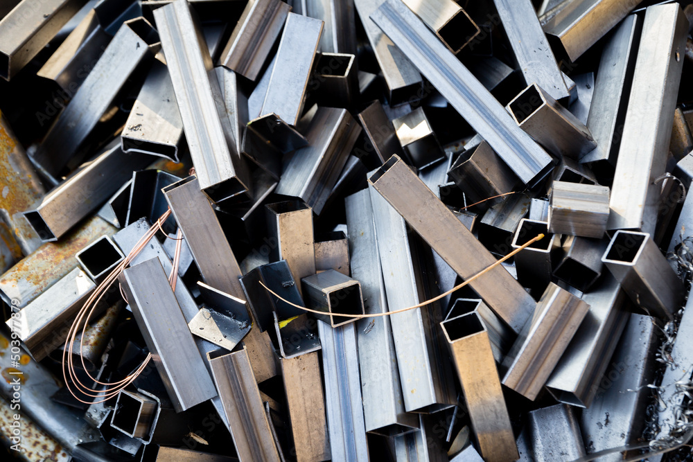 Pieces of metal square pipes from the manufacturing process. Pile of