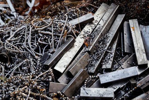 Metal scrap from the manufacturing process. Pile of steel waste prepared for recycling.