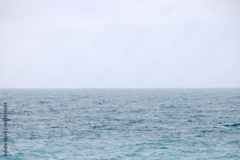 Blue water background. Ripple sea ocean water surface. still calm sea ocean water surface. close up blue water surface at deep ocean. Light blue background - obrazy, fototapety, plakaty 