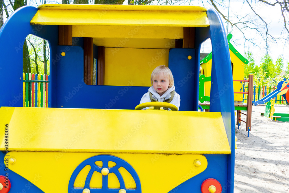 Kidd Rding Inside A Shuttle Cute funny blond little young toddler kid child boy sitting and riding ...