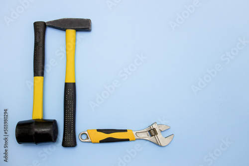 Fotografie hammer, mallet, sanitary key on a light blue background with copy space