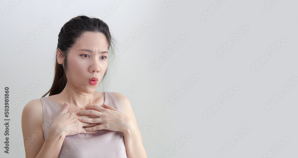 Asian beautiful women raise hand touch her chest with shocked and surprised face when get good and bad news or information or promotion Asian beautiful women raise hand touch her chest with shocked and surprised face when get good and bad news or information or promotion