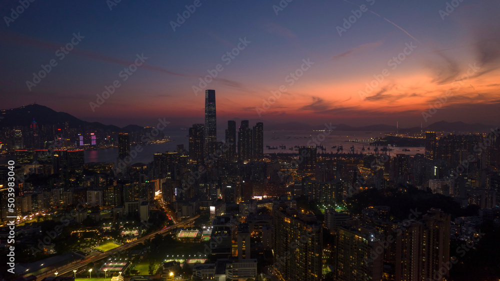 cityscape of Kowloon in Hong Kong, with the after glow of sky on the horizon of land