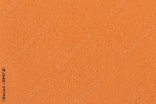 Water droplets on a colored texture. Decorative texture with water drops.