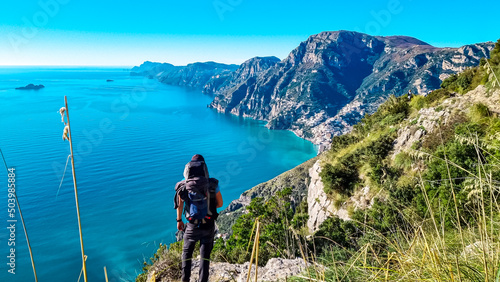 Man with panoramic view from hiking trail Path of Gods between coastal towns Positano and Praiano. Trekking in Lattari Mountains, Apennines, Amalfi Coast, Campania, Italy, Europe. Mediterranean Sea © Chris