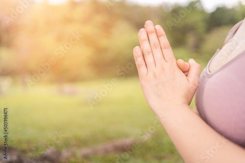 practicing Yoga with hands in prayer position