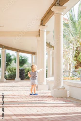 little girl walking in covered walkway