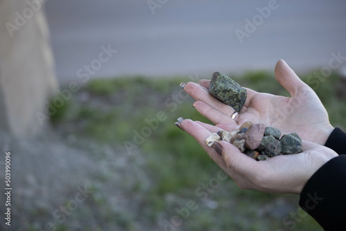 sample a piece of raw biotite genesis rock stone in a hand of a geologist on nature background. High quality photo photo