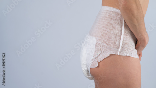 Tableau sur toile Side view of a Woman in adult diapers on a white background