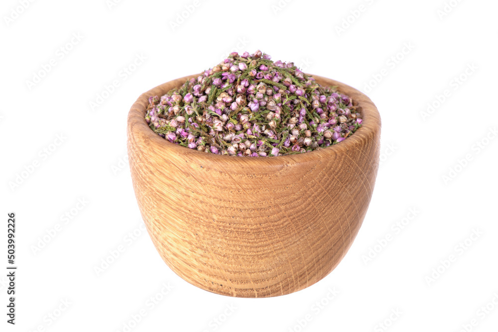 A mound of pink heather in a bowl. Dry heather spice. Heather flower. A mound of pink heather in a bowl. Dry heather spice. Heather flower.