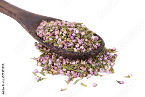 A mound of pink heather in a spoon. Dry heather spice. Heather flower.
