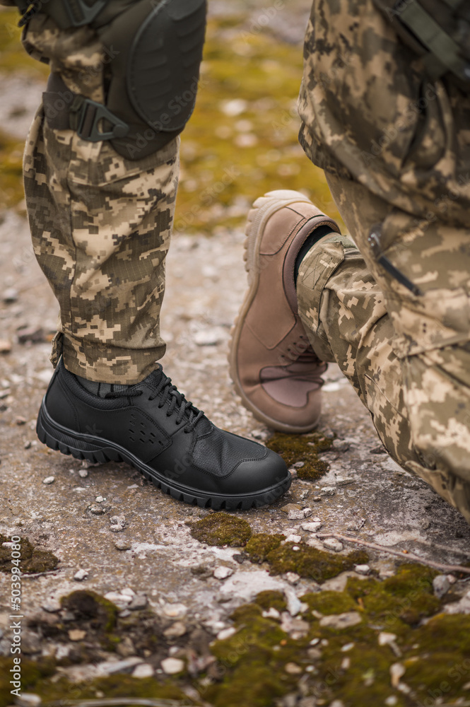 Tactical sneakers on the feet of military men Tactical sneakers on the feet of military men