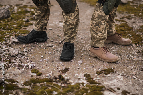 Tactical sneakers on the feet of military men