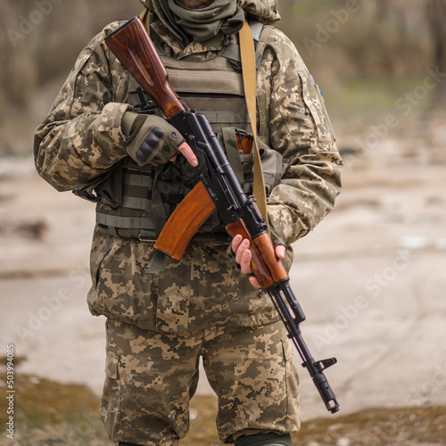 A soldier from Ukraine holds a Kalashnikov assault rifle in his hands