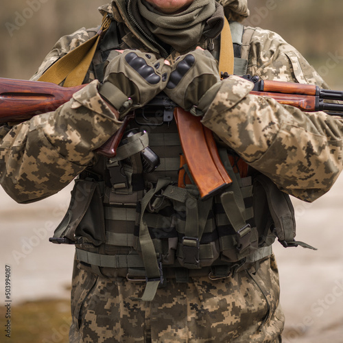 A soldier from Ukraine holds a Kalashnikov assault rifle in his hands
