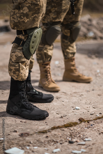 Tactical boots on the feet of military men