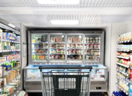 choosing a dairy products at supermarket.empty grocery cart in an empty supermarket