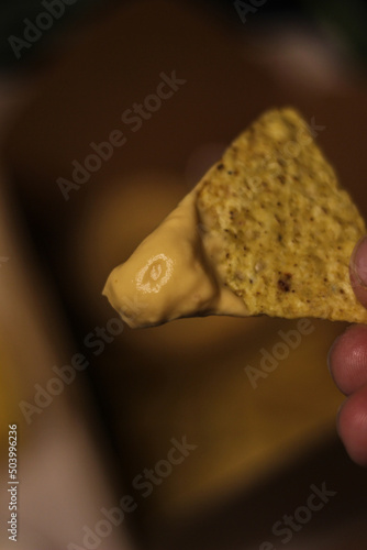 Nacho chips with cheddar cheese sauce for dipping snack mexican food style tex-mex
