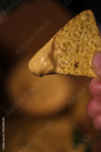 Nacho chips with cheddar cheese sauce for dipping snack mexican food style tex-mex