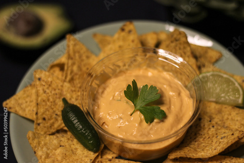 Nacho chips with cheddar cheese sauce for dipping snack mexican food style tex-mex