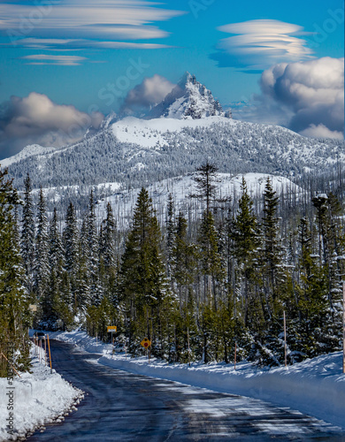 Fényképezés Lenticular clouds over snow covered Three Fingered Jack mountain and access road