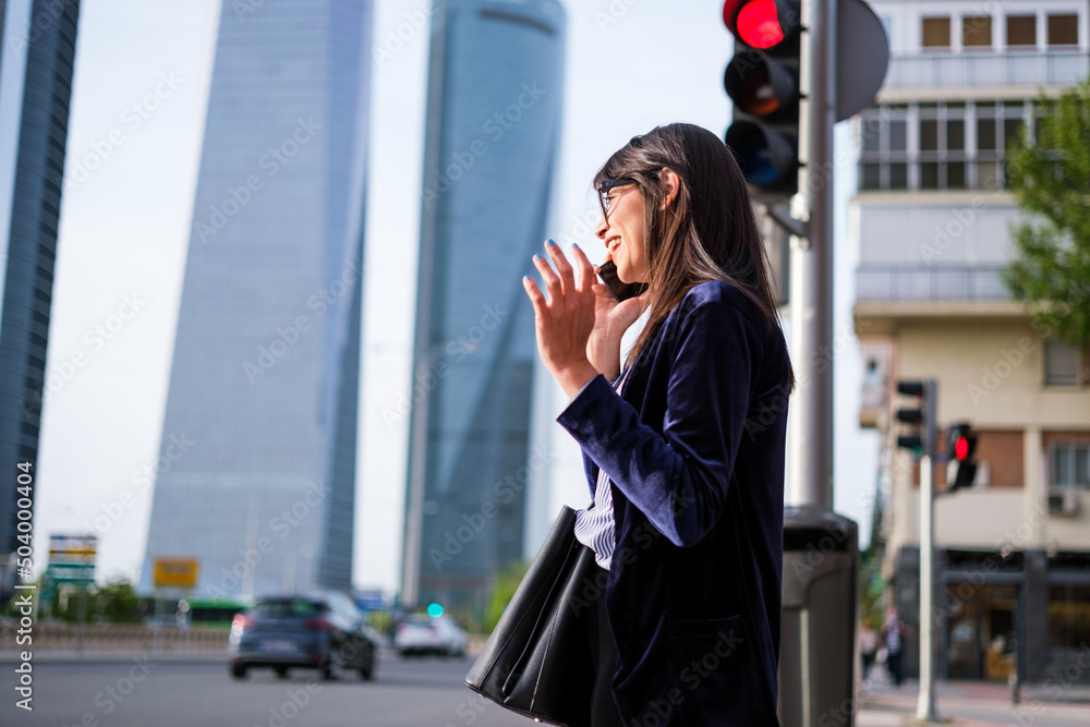 Young woman talking on the phone after work Young woman talking on the phone after work