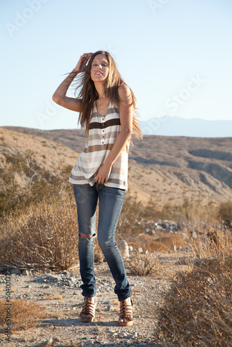 Fun Playful Hipster Model on Vacation Posing in the Desert Mountains in Casual Clothing. Traveler Wanderlust Concept