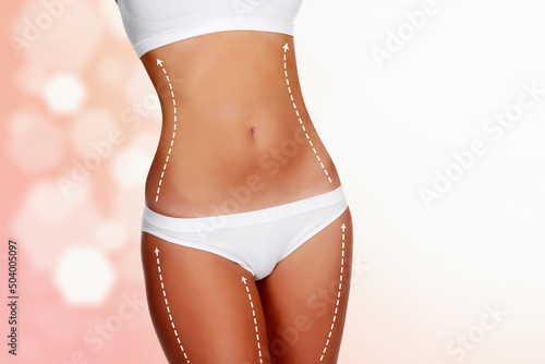 Dotted lines on beautiful female body. Closeup of woman slim fit body with white marks