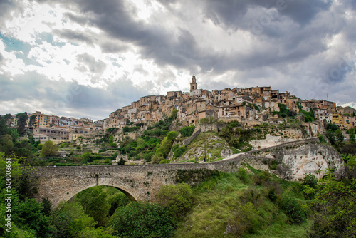 General View of the Beautiful Valencian Village of Bocairent with its Stone Bridge, its Hanging Houses and its Bell Tower on a Cloudy Day. Concept of Rural Tourism in the Valencian Community photo