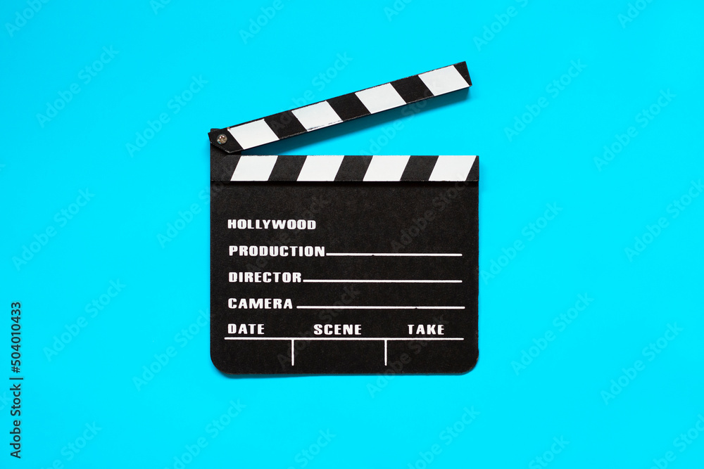 Clapper board isolated on blue background. Film production and movie shooting concept. 