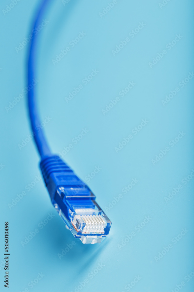 Blue Ethernet Cable Cord Patch cord on a blue background with free space Blue Ethernet Cable Cord Patch cord on a blue background with free space