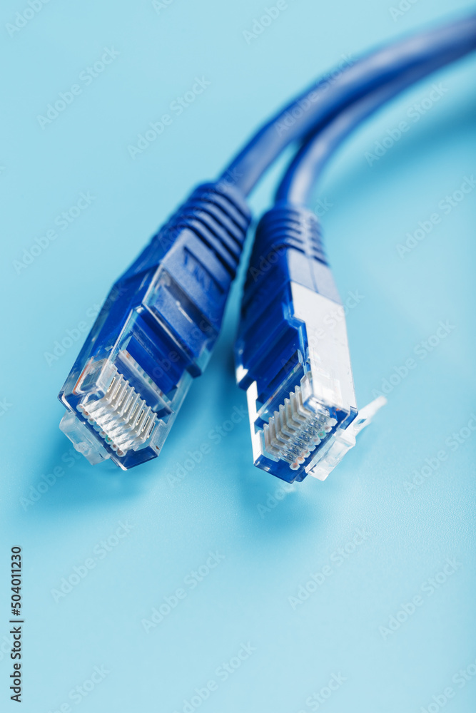 Two Ethernet Cable Connectors Patch cord cord close-up isolated on a blue background with free space Two Ethernet Cable Connectors Patch cord cord close-up isolated on a blue background with free space