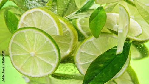 Close up of lime slices in water.