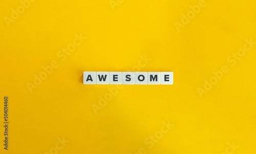 Awesome Word on Letter Tiles on Yellow Background. Minimal Aesthetics.