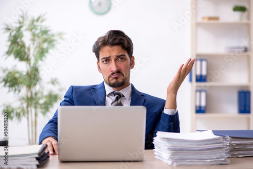 Young male employee working in the office