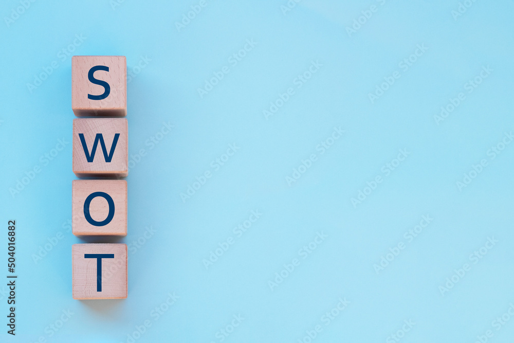 Word SWOT on wooden cubes. Business analysis concept with copy space. Word SWOT on wooden cubes. Business analysis concept with copy space.