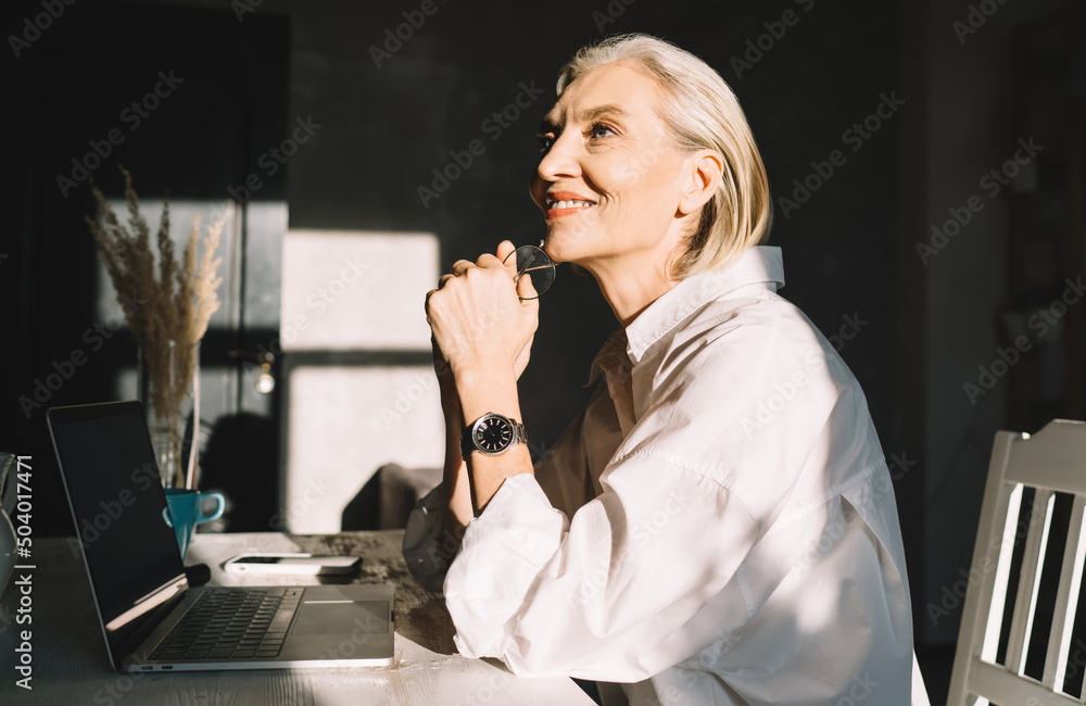 Female entrepreneur working at table at art studio Female entrepreneur working at table at art studio
