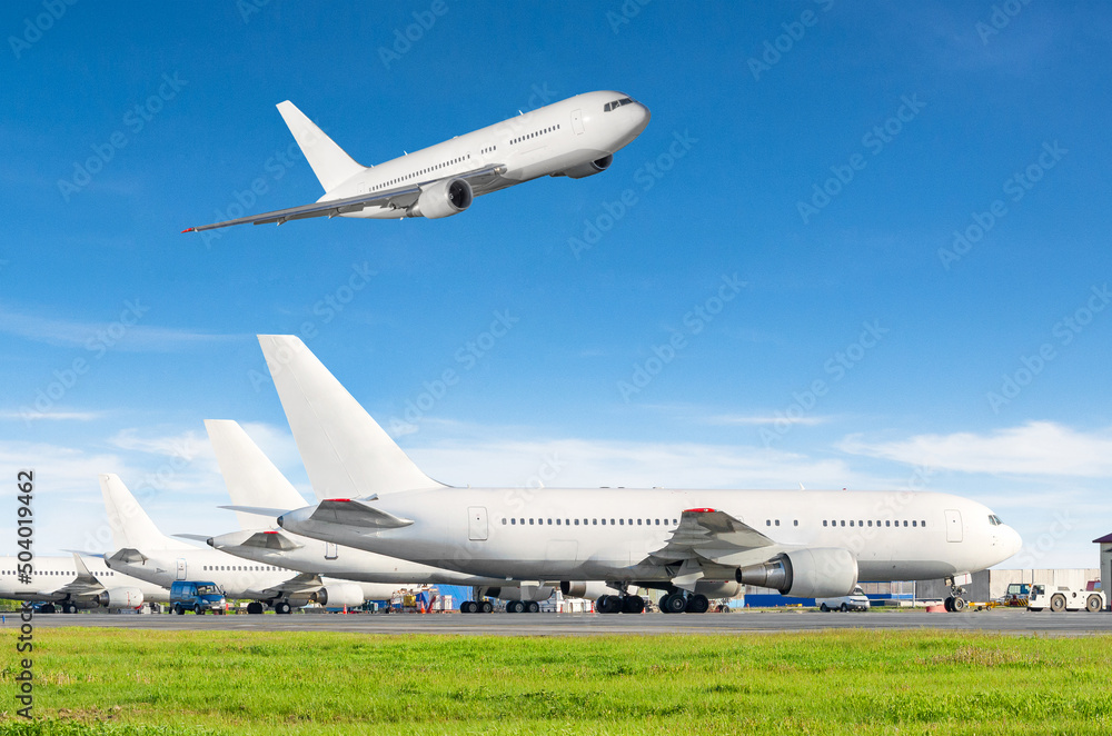 Airport with many airplanes and flying plane in the sky. Airport with many airplanes and flying plane in the sky.
