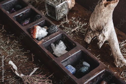 A collection of various different crystals on a messy wiccan witch's altar. Crystal magick