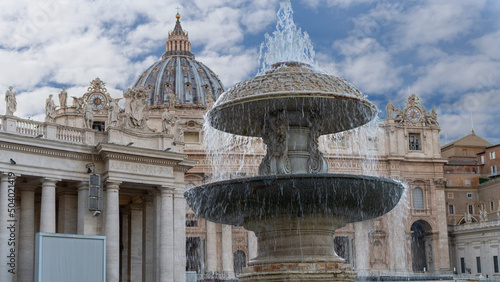 Vatican, Rome, Italy - October 9, 2019 - beautiful old fountain with St. Peter's Basilica in the background