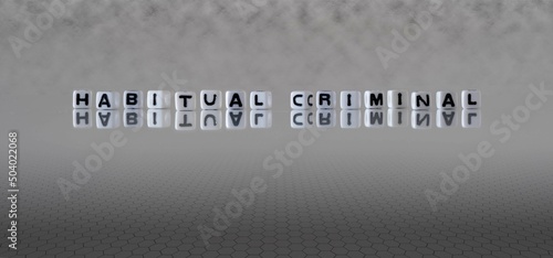 habitual criminal word or concept represented by black and white letter cubes on a grey horizon background stretching to infinity