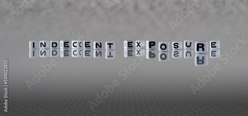 Foto indecent exposure word or concept represented by black and white letter cubes on